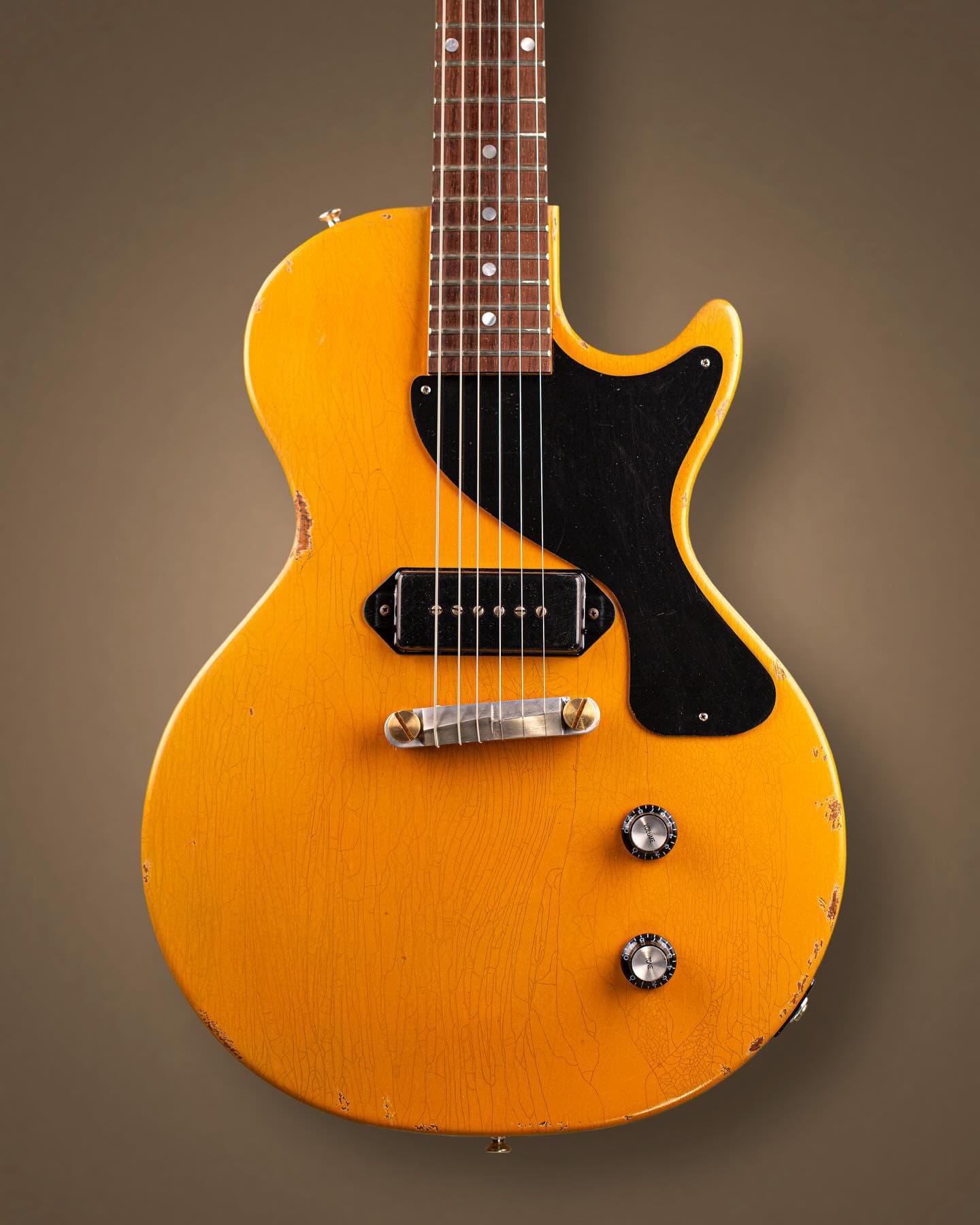 Les Paul Junior en TV Yellow con la laca cuarteada, fotografiada de frente sobre fondo neutro
